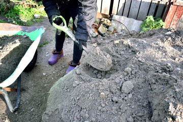 load small gravel into a cart with a shovel, close-up