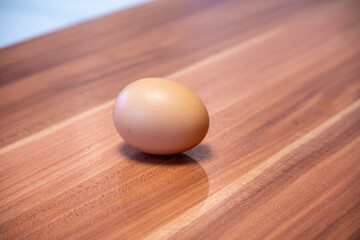 on kitchen worktop lies a brown chicken egg