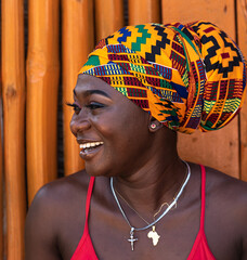 Happy African woman in the small village of Keta located in Ghana, dressed in African headdress