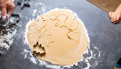 christmas and new year holidays, mom and children prepare gingerbread cookies