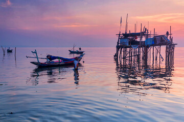 Beautiful view on sunrise with wooden boat as a subject at Kenjeran beach,Surabaya.Indonesia