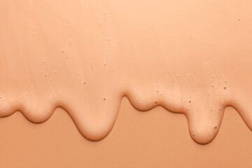Cream orange transparent cosmetic sample texture with bubbles background