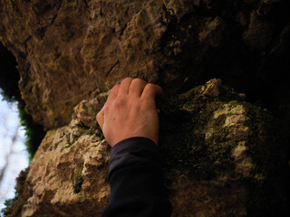 hand of a man climbing in the mountains