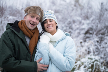 Fototapeta premium Couple in love at winter park. Love couple. Winter day. Snow background. Man and woman nature. 