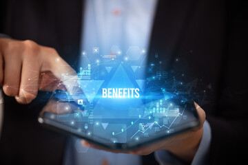 Businessman holding a foldable smartphone with BENEFITS inscription, business concept