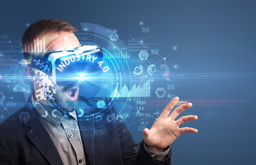 Businessman looking through Virtual Reality glasses with INDUSTRY 4.0 inscription, innovative technology concept