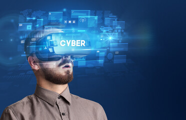 Businessman looking through Virtual Reality glasses with CYBER inscription, innovative security concept