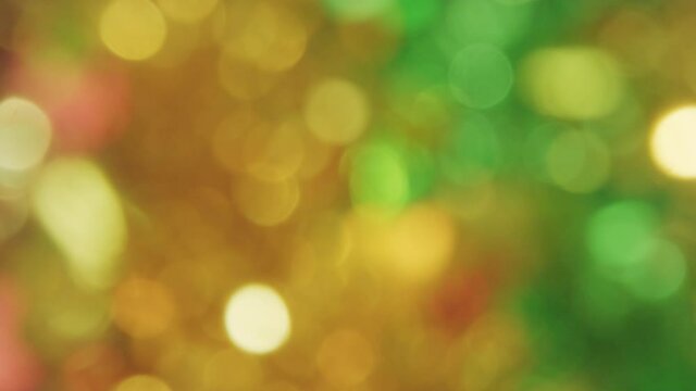 Real colorful bokeh from shiny tinsel garlands for New Year and Christmas