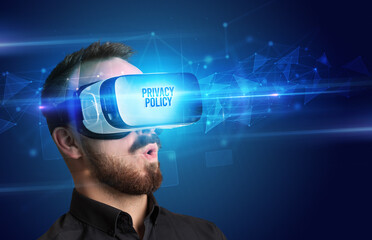 Businessman looking through Virtual Reality glasses with PRIVACY POLICY inscription, cyber security concept