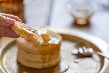 Moroccan Harcha Semolina pan fried. Flatbread served with honey or syrup made from melted butter and honey. Harcha is a traditional breakfast from the north of Africa