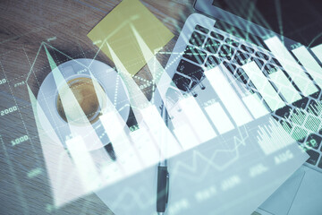 Double exposure of forex chart drawing over table background with computer. Concept of financial research and analysis. Top view.