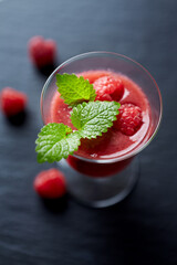 Fresh smoothie in a glass. Dark background. Close up.	