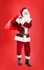 Santa Claus with sack on red background