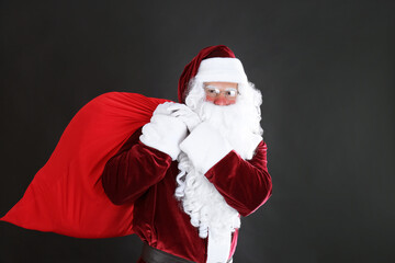 Portrait of Santa Claus with sack on black background