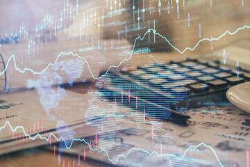 Double exposure of financial chart drawings and desk with open notebook background. Concept of forex market