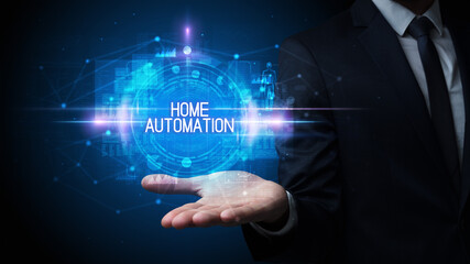 Man hand holding HOME AUTOMATION inscription, technology concept