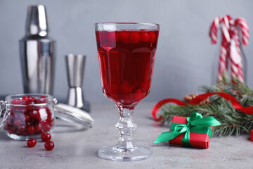 Delicious Christmas liqueur on grey table, closeup