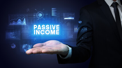 Hand of Businessman holding PASSIVE INCOME inscription, business success concept