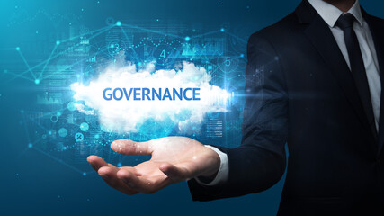 Hand of Businessman holding GOVERNANCE inscription, successful business concept