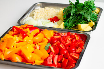 Chopped ingredients for making oriental vegetable stew. Paprika, potatoes, onions, tomatoes, garlic, peppers, spices.