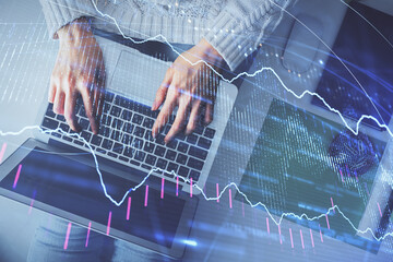 Multi exposure of woman hands working on computer and forex chart hologram drawing. Top View. Financial analysis concept.