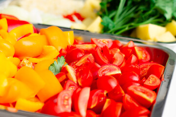 Chopped ingredients for making oriental vegetable stew. Paprika, potatoes, onions, tomatoes, garlic, peppers, spices.