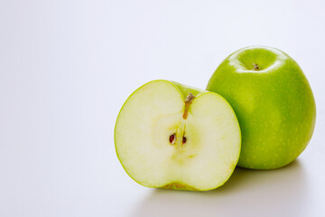 Green cut apple and isolated on white background.