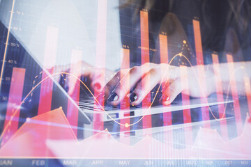 Double exposure of woman hands typing on computer and forex chart hologram drawing. Stock market...