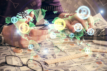 Double exposure of man's hands holding and using a digital device and forex graph drawing. Financial market concept.