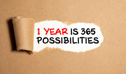 Text appearing behind torn brown envelop - 1 Year, 365 possibilities