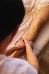 Foot massage procedure at the spa, a man receives a comprehensive massage.