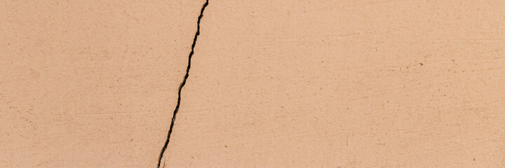 Old wall with cracked plaster. Weathered rough surface. Wide panoramic texture for background and design.