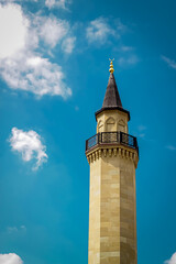 Fototapeta premium The minaret of the Muslim mosque against the background of the cloudy sky. minaret directed to the sky. Kiev, Ukraine. Ar-rahma mosque 