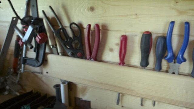 Close up organizing carpentry tools in woodworker workshop. DIY concept.