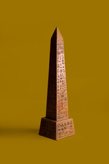 Egyptian obelisk with yellow background, symbol of power