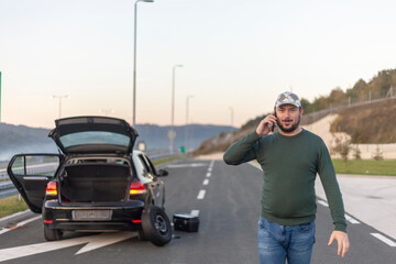 Man talking on cell phone, highway problem with car