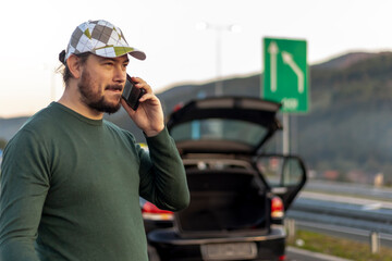 A frustrated, angry, impatient driver makes a phone call and asks for help on the road