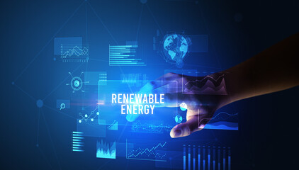 Hand touching RENEWABLE ENERGY inscription, new business technology concept