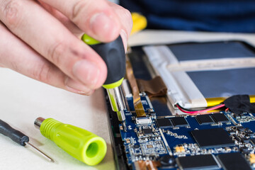 close up image of smart phone and tablet repair, in technology lab.