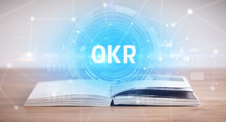 Open book with OKR abbreviation, modern technology concept