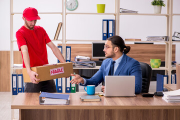 Young man delivering parcel to the office