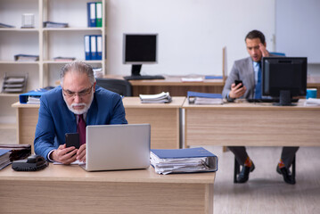 Two male employees working in the office