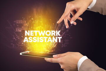 Close-up of a touchscreen with NETWORK ASSISTANT inscription, innovative technology concept