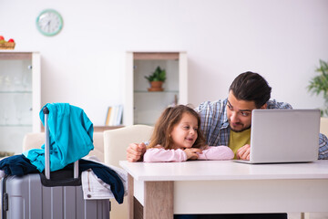 Young man and his small daughter preparing for the trip