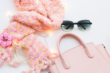 knitting wool scarf ,perfume ,sunglasses and pink hand bag of fashion lifestyle woman relax in winter season on table white