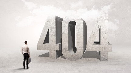 Rear view of a businessman standing in front of 404 abbreviation, attention making concept