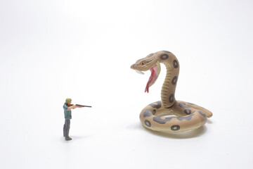a mini of figure man shooting the big snake
