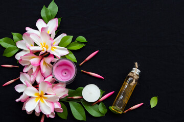 Obraz na płótnie Canvas natural herbal oils from flower pink frangipani smells scents aroma local of asia arrangement flat lay postcard style on background black