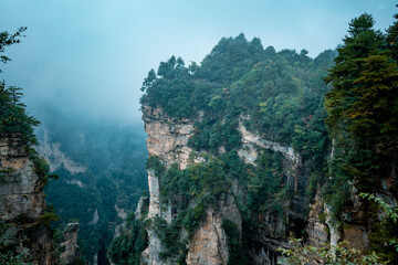 Fototapeta na wymiar Amazing landscape of mountain and forest in the foggy at Wulingyuan, Hunan, China. Wulingyuan Scenic and Historic Interest Area which was designated a UNESCO World Heritage Site in China