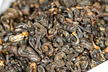 Chinese red tea Red Curls (Dianhong Hong Luo). Macro image with blurred background.